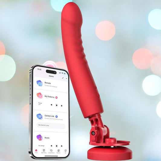 The Lovense Mission 2 Vibrating Suction Cup Dildo in red is shown next to a smartphone using the Lovense Remote app with settings options. A softly blurred, multi-colored light background highlights its advanced Touch-Sense Technology. 1080