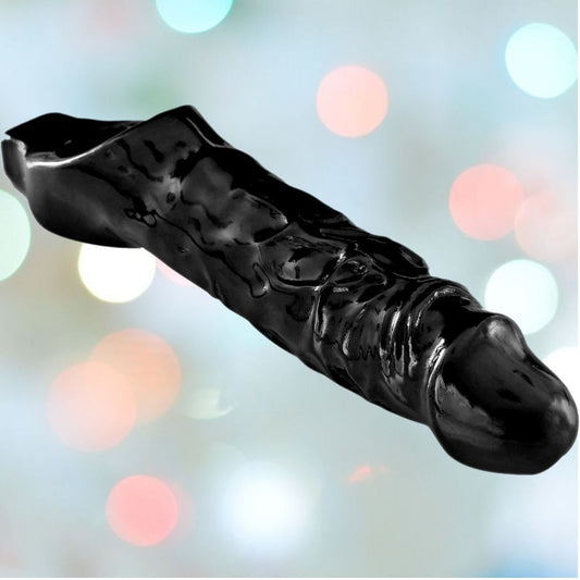 A glossy sculpture in the shape of a boot, featuring abstract design elements and finished in black, stands boldly against a blurred background of colorful lights, capturing the innovative essence of the Mamba Cock Sheath Penis Extender by Mamba. 1080