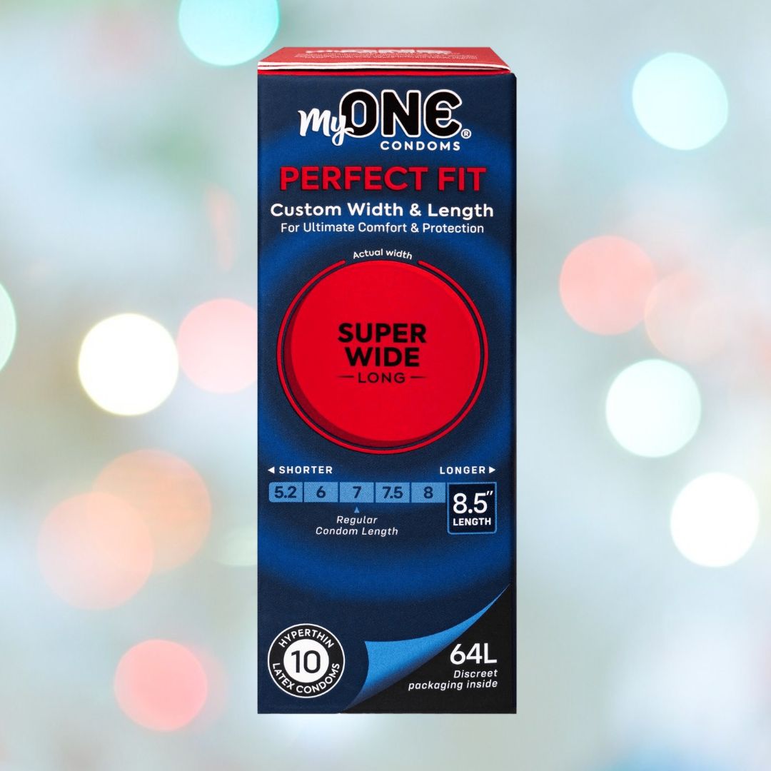 A box of MyONE Super Wide & Long 64L - 8.5" Long condoms (10 count), with a width of 7.8 cm and length of 8.5", is shown against a blurred, colorful background.
