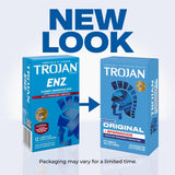 Two blue Trojan condom boxes are shown side by side with an arrow in between—one labeled "ENZ" on the left and "ORIGINAL" on the right. The text above says "NEW LOOK," with a note below: "Packaging may vary for a limited time." Featuring trusted Trojan ENZ Armor Spermicidal Condoms, standard thickness condoms designed by Trojan for reliable protection.