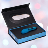 The Nu Sensuelle Nikita High-Power Nitro Bullet Vibrator in Deep Turquoise by NOVEL CREATIONS USA is shown in a sleek black and blue box labeled “POWER THAT DOMINATES,” set against a softly blurred, pastel-hued background.