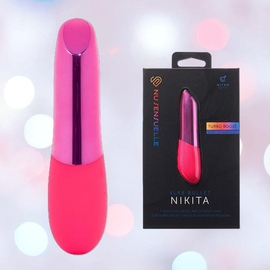 A pink Nu Sensuelle Nubii Raine Tapping Vibrator with Warming and Turbo Boost by NOVEL CREATIONS USA is shown beside its sleek black packaging, softly lit to highlight this discreet, waterproof vibe designed for powerful clitoral pleasure. 1080