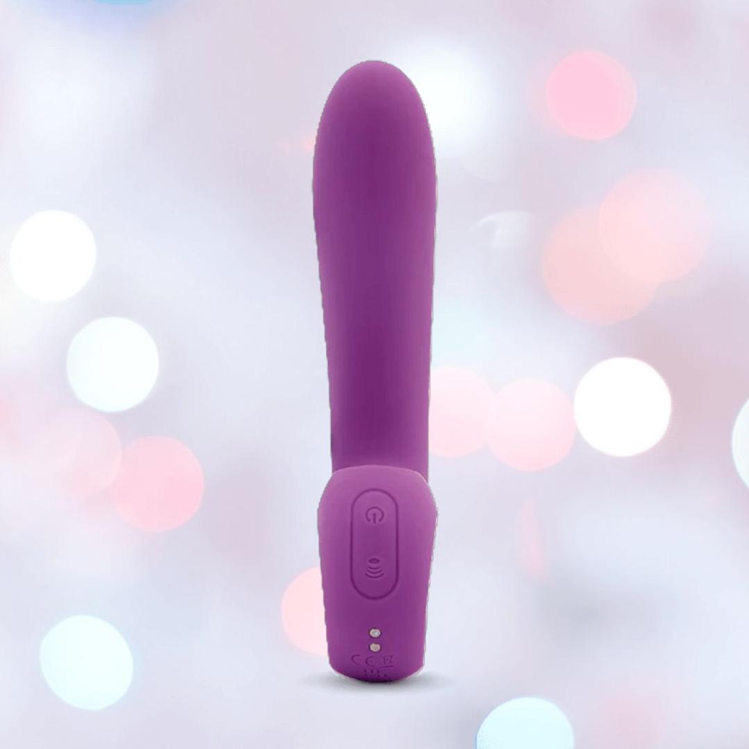 The Nu Sensuelle Nubii Raine Tapping Vibrator with Warming and Turbo Boost by NOVEL CREATIONS USA stands upright, showcasing its purple hue, rounded tip, and base control buttons against a soft pastel bokeh background.