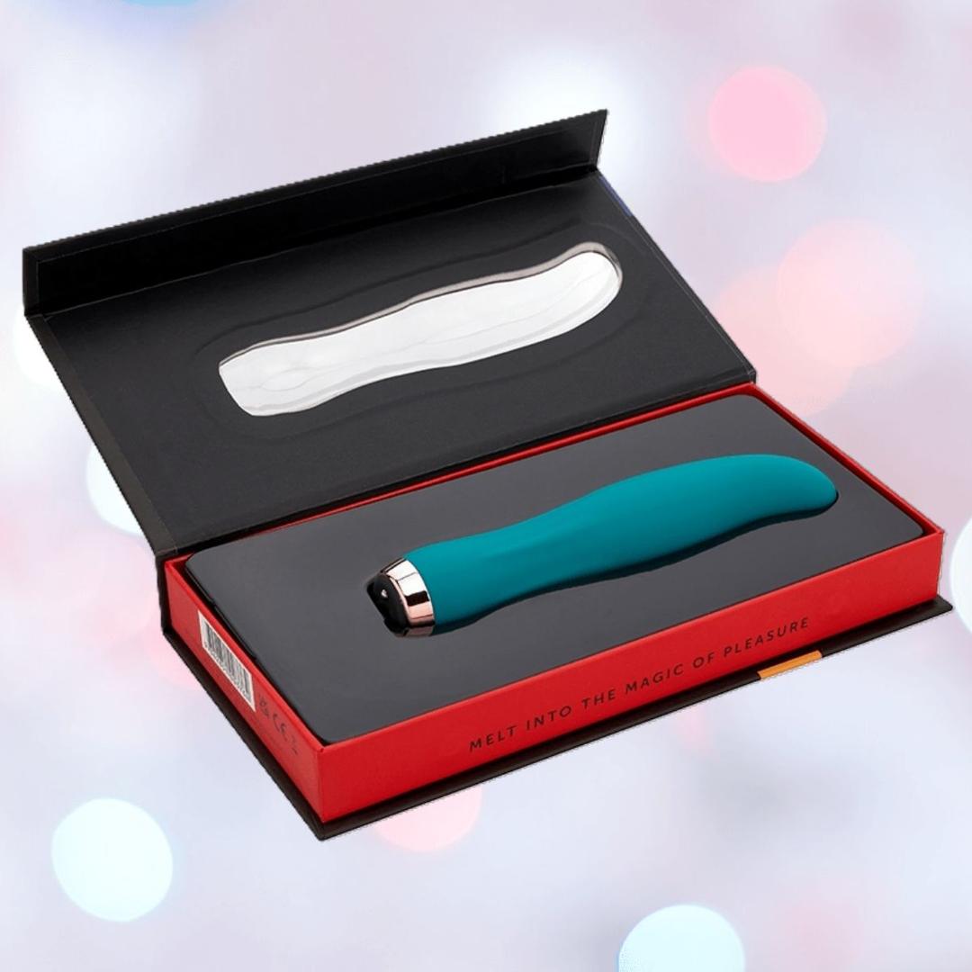 The Nu Sensuelle Velvet Touch Bella Vibrator with Turbo Boost by NOVEL CREATIONS USA in emerald green is made from body-safe silicone and comes in a black and red gift box reading "Melt into the magic of pleasure.