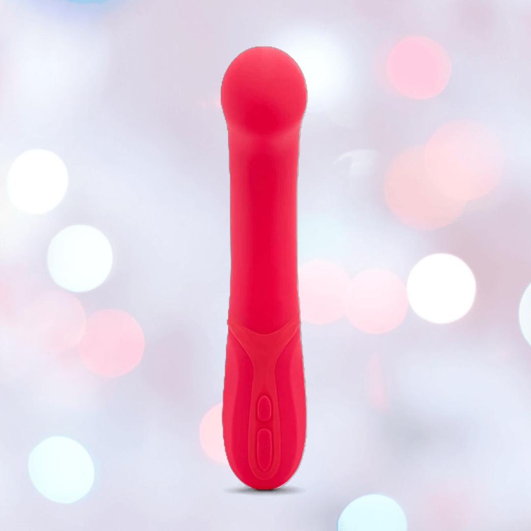 The Nu Sensuelle Velvet Touch Luna Vibrator with Turbo Boost by NOVEL CREATIONS USA in hot pink stands upright, showcasing its rounded tip and dual-handle buttons, and offers 20 vibration patterns against a softly blurred pastel background.