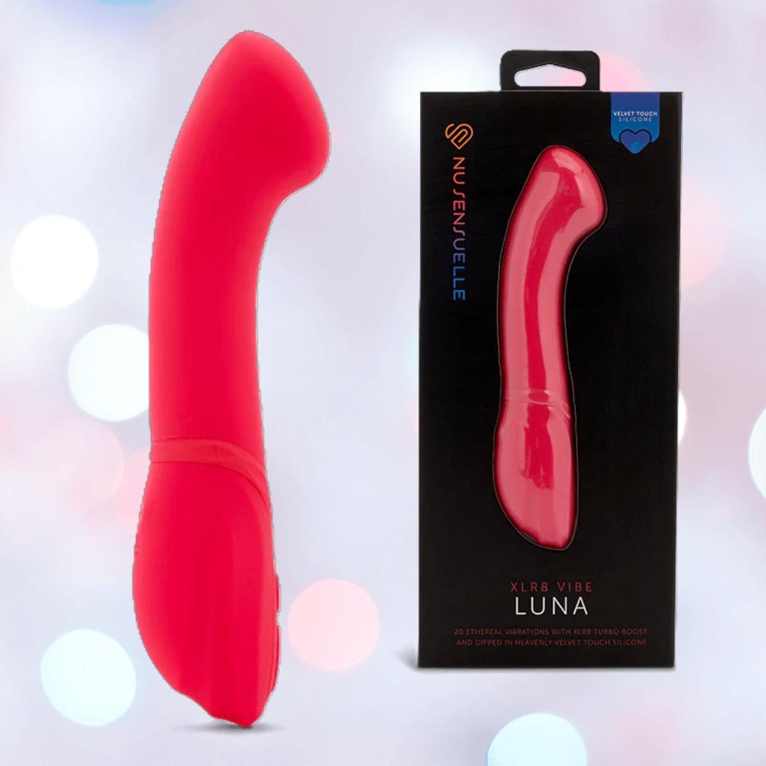 The Nu Sensuelle Velvet Touch Luna Vibrator with Turbo Boost in hot pink by NOVEL CREATIONS USA is shown beside its black box, featuring the product image and logo. The background glows with soft, blurred lights.