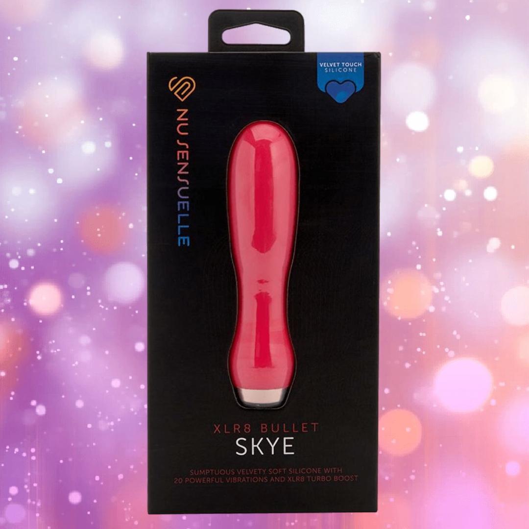 The Nu Sensuelle Velvet Touch Skye - Hot Pink by NOVEL CREATIONS USA, featuring 20 vibration settings and soft silicone, is showcased in its sleek black box against a sparkling purple and pink background.