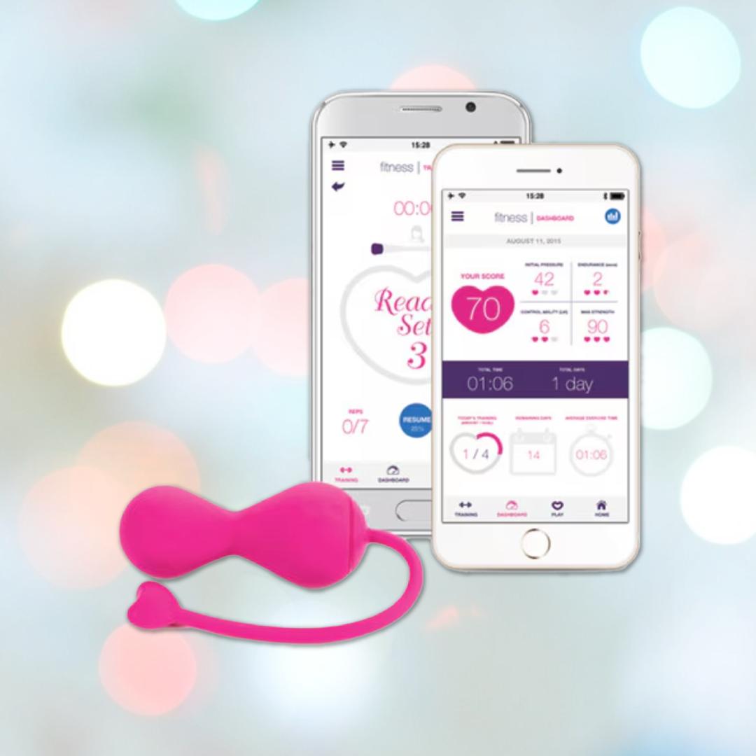 The OhMiBod Lovelife Krush Smart Kegel Fitness in pink by OhMiBod, featuring Bluetooth and a heart-shaped end, is displayed before two smartphones with a pelvic floor fitness tracking app on a soft pastel background.