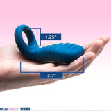 A person is holding an OhMiBod blueMotion NEX|3-Navy Blue Couple's Ring, crafted from body-friendly silicone and measuring 1.25 inches by 3.7 inches. The background showcases a pink gradient, emphasizing the sleek design of this Bluetooth-enabled wearable made by OhMiBod.