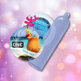 A blue ONE Island Punch Flavored Condom 🍍 is displayed next to two round ONE condom packages, one featuring a tropical cocktail, highlighting ultra-thin latex condoms against a vibrant, bokeh-style background.