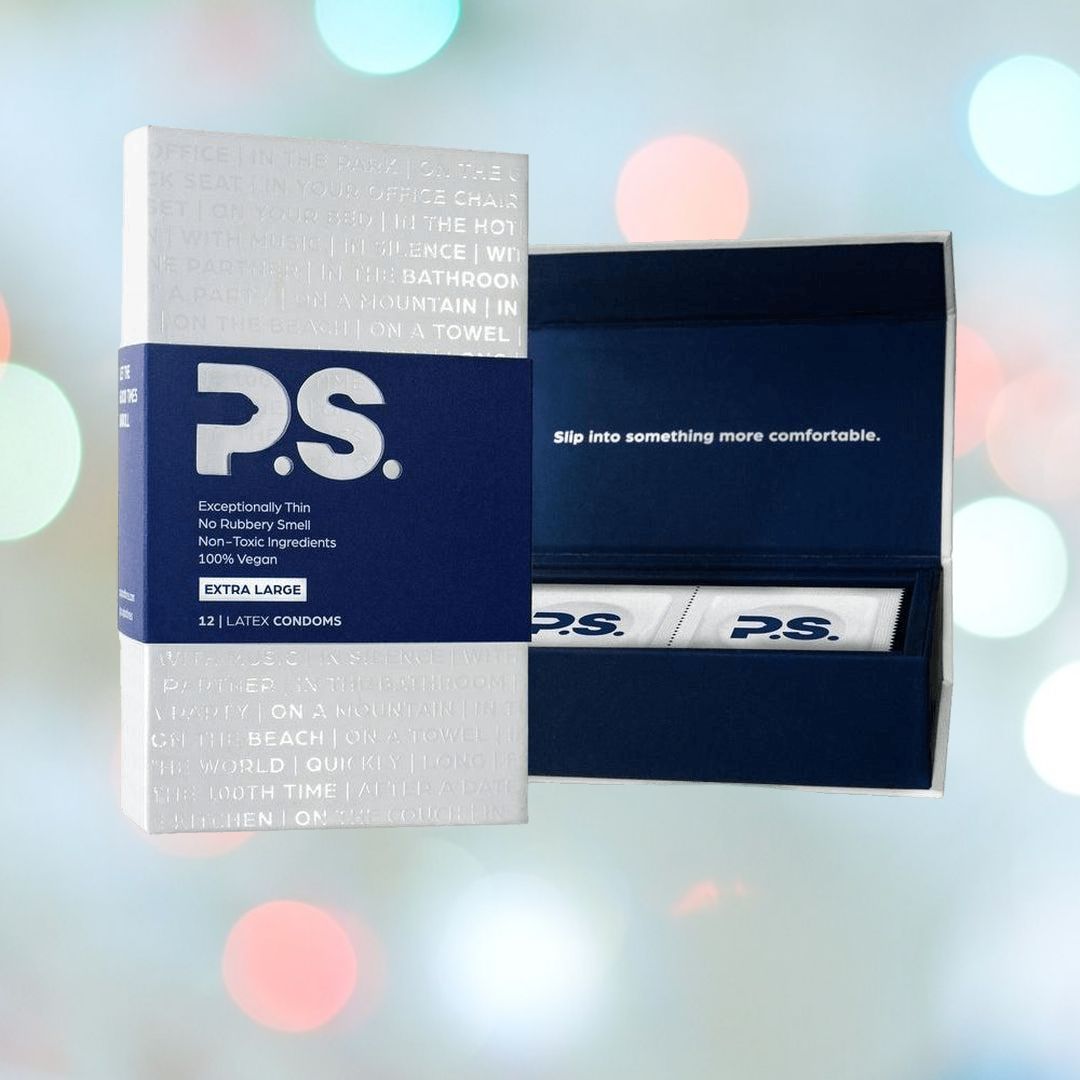 A package of P.S. XL Ultra-Thin Large Condoms from P.S. Condoms is displayed. The box boasts a blue and white design, emphasizing non-toxic ingredients and exceptional thinness. Prominently identified as vegan condoms, the inside lid invites you to "slip into something more comfortable.