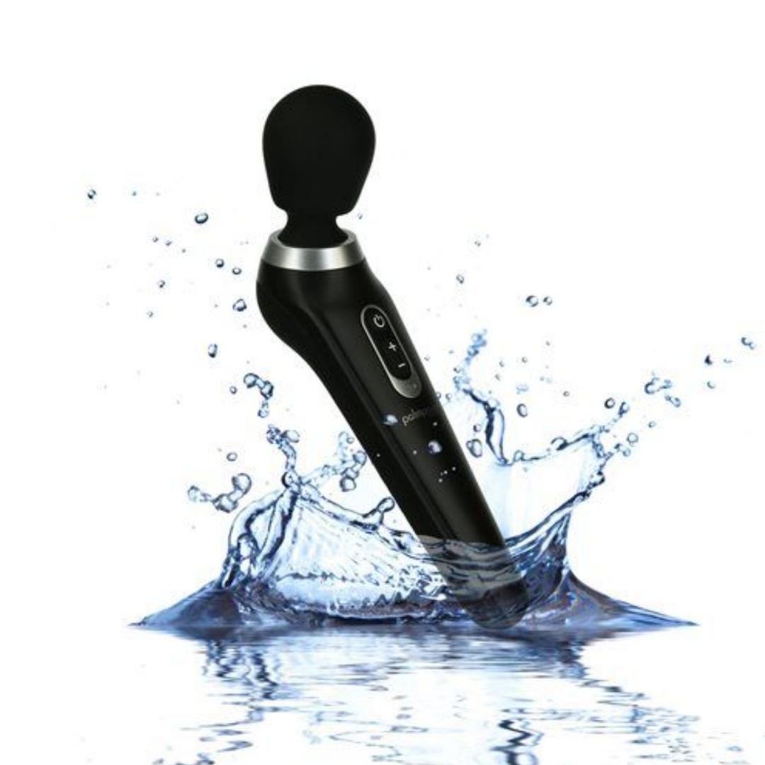 The PalmPower Extreme Wand Massager - Black by BMS, with a round head, is shown splashing into water against a white background to highlight its waterproof design.
