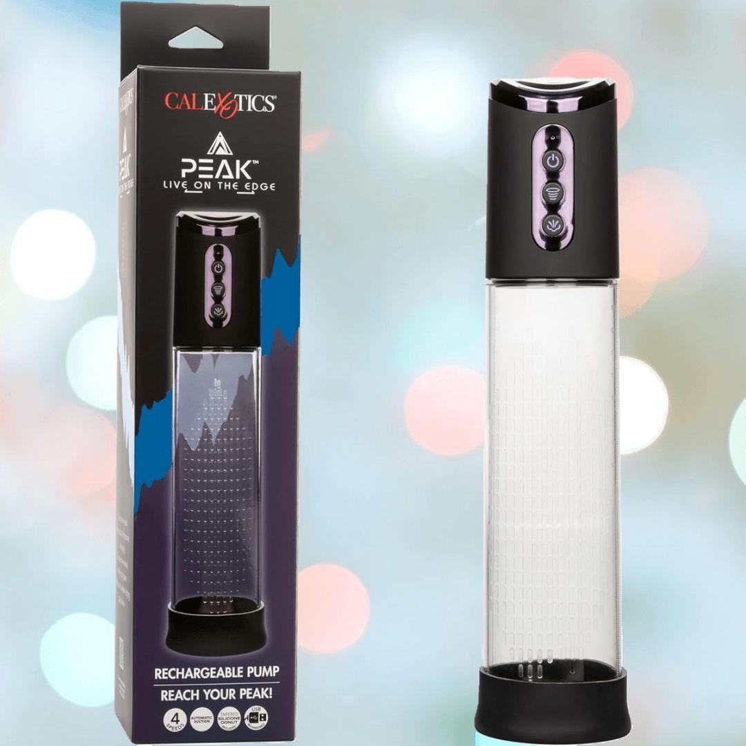 The CalExotics Peak Rechargeable Penis Pump features a transparent chamber, black top, and blue mountain design on its box. It offers automatic suction pump technology for intimate enhancement and is shown next to its product packaging.