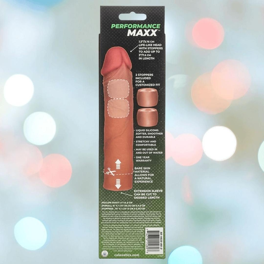 The image shows the packaging for CalExotics' Performance Maxx Liquid Silicone Extension System - Brown, highlighting its realistic shaft sleeve, custom fit stoppers, and body-safe silicone features against a blurred background.