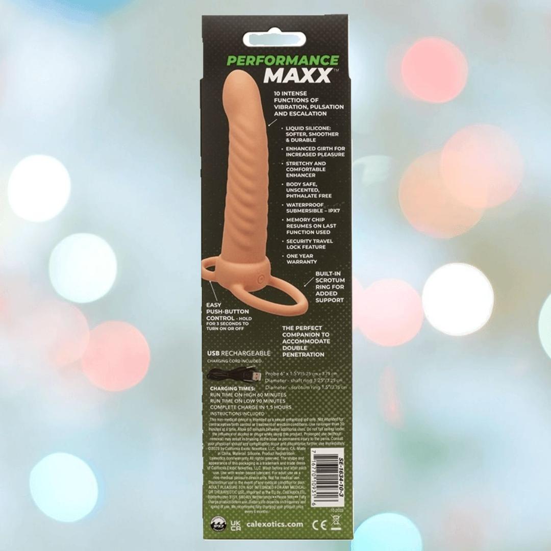The CalExotics Performance Maxx Rechargeable Ribbed Dual Penetrator - Ivory comes in packaging with product features, use instructions, and company info, featuring its textured beige dual penetrator design and a handle against a blurred light background.