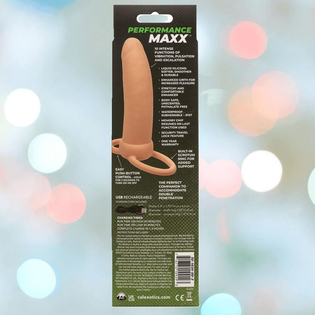 The Performance Maxx Rechargeable Thick Dual Penetrator - Ivory by CalExotics comes in a package displaying the toy, USB rechargeability, silicone construction, and multiple vibration functions against a blurred backdrop.