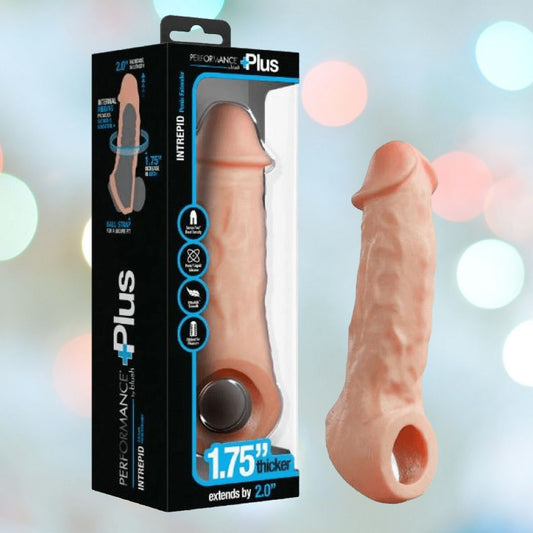 The image showcases a packaged adult novelty item, identified as the "Performance Plus Intrepid 2" Penis Xtender - Beige" from Blush Novelties. This realistic beige penis extender is designed with dual-density silicone to provide added length and girth, featuring a thickness increase of 1.75 inches and an extension of 2 inches. The package is elegantly designed in black with blue accents. 1080