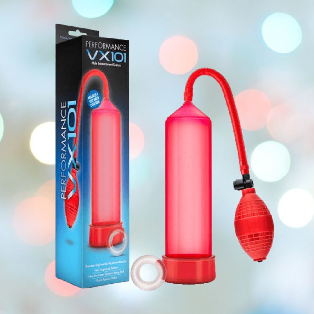 A red Performance VX101 Enhancement Pump, featuring a bulb, pressure gauge, and medical-grade ball pump, is placed next to its packaging. The box prominently displays the name "Performance VX101." In the background, blurred circular light patterns accentuate its sleek design by Blush Novelties for enhancement purposes. The product also includes a FREE Stay Hard Cock Ring.