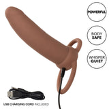 The CalExotics Performance Maxx Rechargeable Thick Dual Penetrator in brown features two rings, a USB charging cord, and is highlighted as “Powerful,” “Body Safe,” and “Whisper Quiet.” An extra USB charging cord is also included.