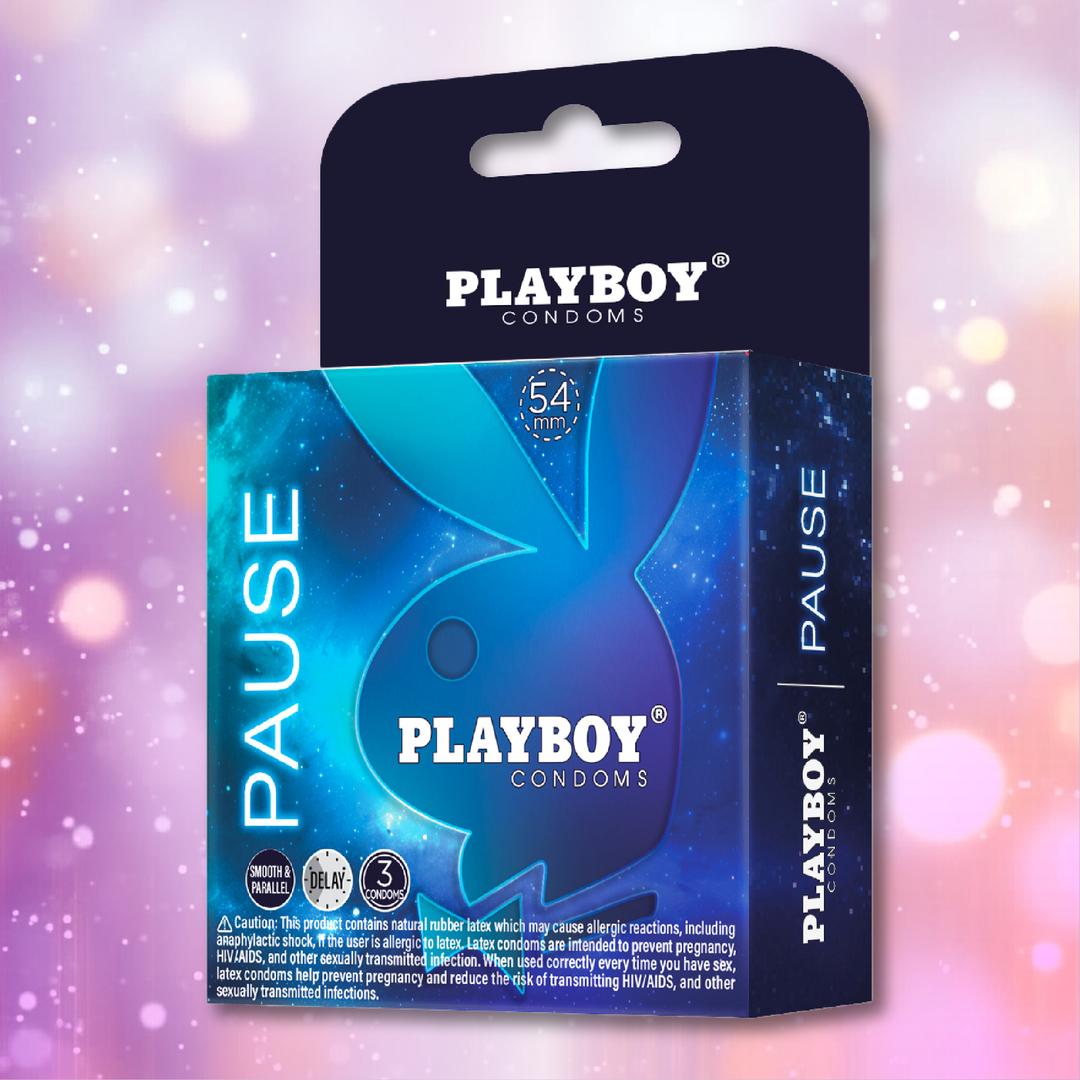 A box of Playboy Condoms - Pause Play Longer (3 premium lubricated condoms, 54mm) with the iconic bunny logo and blue design is shown against a pink and purple bokeh background.