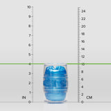 A transparent capsule containing a blue object, the Fleshlight Quickshot Alien Blue Male Masturbator (Mouth & Butt) by Fleshlight, stands upright between inch and centimeter rulers, measuring about 4 inches (10 cm) tall.