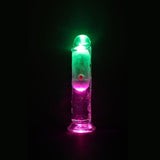 The RealRock Wireless Rechargeable LED Vibrating 6" by Shots America glows with green and pink lights against a black background.