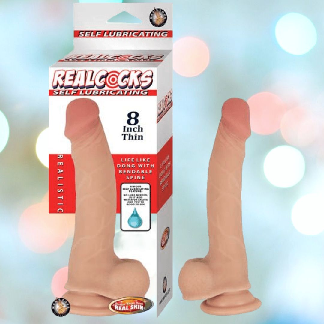 Packaging for Nasstoys' sex toy labeled "Realcocks Self-Lubricating Dong 8" Thin." The image shows the box and the product, which is a realistic, flesh-toned dildo with a suction base and a bendable spine. The background is blurred with soft, pastel-colored lights, adding to its Hollywood realism.