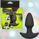A black Rock Bottom Thrusting Probe by CalExotics is displayed beside its packaging, which features a bright green and black design with product details. The box reads "Rock Bottom Thrusting Probe" and "Party in the Rear!.