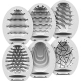 A 6-pack of Satisfyer Masturbator Stroker Eggs features gray, textured, egg-shaped designs ideal for collection. Displayed in a grid, each egg has a unique internal pattern—waves, bumps, ridges—for unmatched sensation and easy portability.