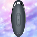 The Satisfyer Tap and Climax 2 Lay-On Vibrator by Satisfyer is a sleek black, oval-shaped device featuring a wavy button and plus/minus controls, set against blurred pastel purple and pink lights.