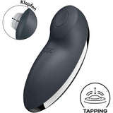 The Satisfyer Tap and Climax 2 Lay-On Vibrator by Satisfyer is a black, curved personal massager with a round top button. An inset highlights its tapping motion, with “TAPPING” and an icon in the lower right corner.