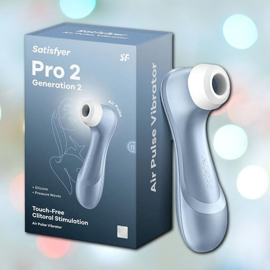 A blue Satisfyer Pro 2 Air Pulse Stimulator is displayed next to its box with a line art of a woman. The whisper-quiet motor and Air-Pulse Technology offer touch-free clitoral stimulation using silicone and pressure waves. 1080