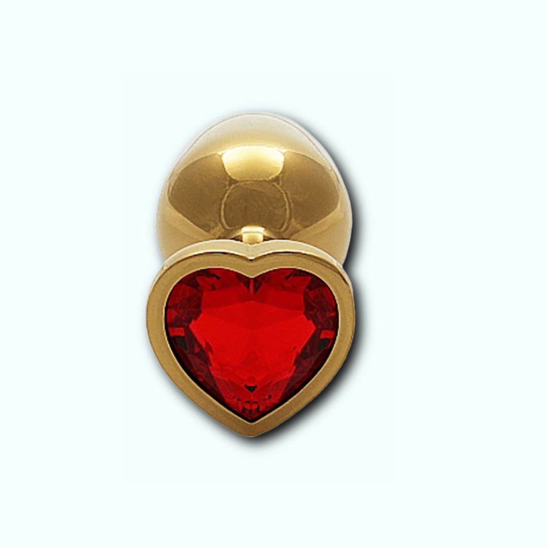 The Shots Ouch! Heart Gem Butt Plug Small - Gold/Ruby Red by Shots features a heart-shaped ruby red gemstone embedded in the base. With its tapered tip for easy insertion and elegant design, this glamorous piece is perfect for those interested in temperature play and adds a touch of sparkle to your intimate moments.