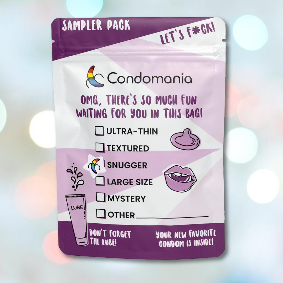 The Condomania Snugger Fitting Condom Sampler includes snug-fit and ultra-thin options, textured and large sizes, a mystery choice, plus a lube reminder. The soft sky background with light bokeh effects complements this diverse collection.