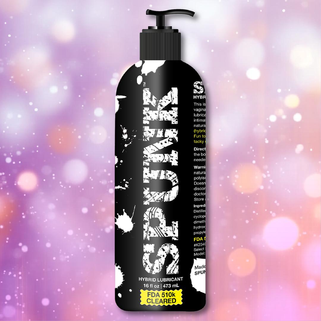 A black pump bottle labeled "SPUNK," contains 16 oz of SPUNK Hybrid Lubricant by Spunk Lube. The backdrop shows pink and purple bokeh with white sparkles and "FDA 510K CLEARED" highlighted in yellow.