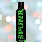 A black bottle of Spunk Lube's SPUNK Pure Silicone Lubricant with green text stands against a blurred background of multicolored bokeh lights, showcasing its hypoallergenic formula and long-lasting slippery texture.