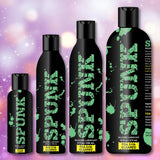 Four black bottles of Spunk Lube’s SPUNK Pure Silicone Lubricant, featuring bold green lettering and displayed in a row against a vibrant backdrop, showcase this premium, long-lasting personal lubricant.