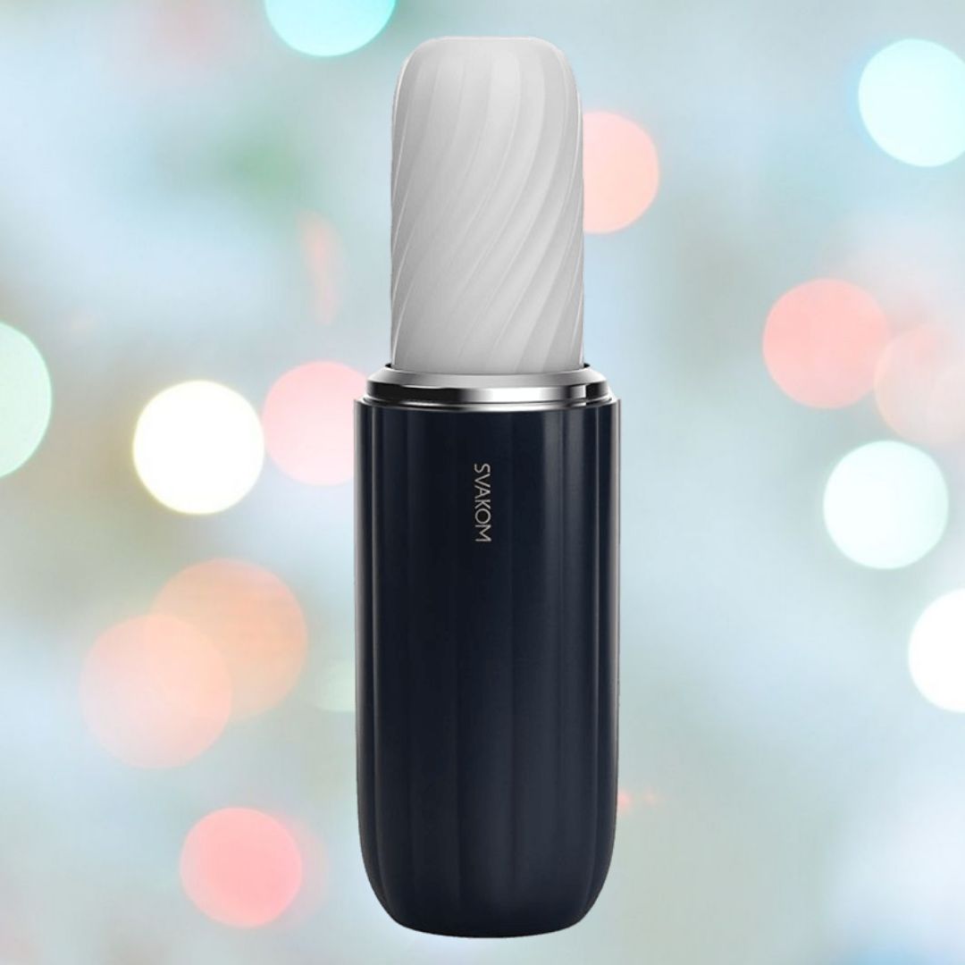 A sleek, cylindrical device with a textured white top and glossy black body is set against a blurred background featuring soft, colorful lights. The advanced technology of the Svakom Alex Neo 2 Thrusting Male Masturbator is evident, with "Svakom" printed vertically on the side.