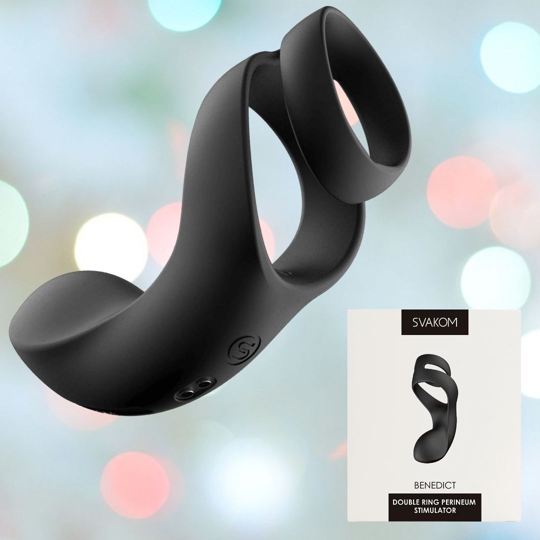 A black, ergonomically designed vibrating ring is showcased against a softly blurred light background. Made from body-safe silicone, it provides powerful vibrations. Beside it lies a box presenting the product, prominently featuring the name "Svakom Benedict Double Ring Perineum Stimulator - Black.