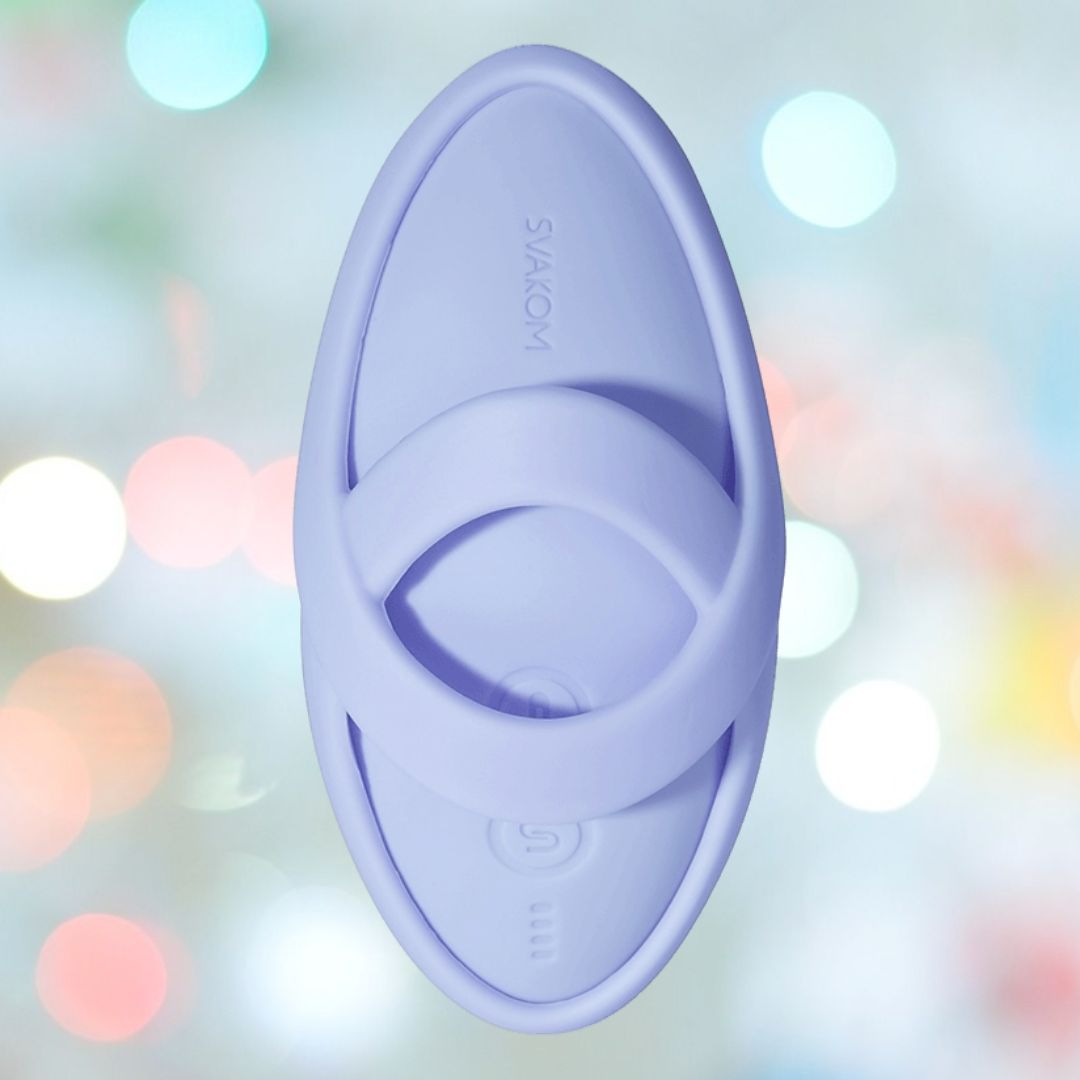 A sky blue, oval-shaped Svakom Echo 2 Finger Vibrator with a central handle and "Svakom" embossed is shown against a soft, colorful bokeh background.