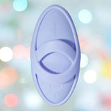 A sky blue, oval-shaped Svakom Echo 2 Finger Vibrator with a central handle and "Svakom" embossed is shown against a soft, colorful bokeh background.