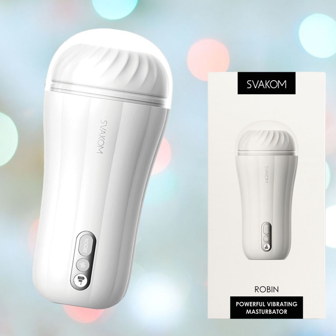 The image features a Svakom Robin Vibrating Masturbation Sleeve in white. This cylindrical device, complete with a textured cap and intuitive buttons at the base, is placed next to its product box which displays matching imagery. A dreamy background with multicolored bokeh accentuates the uniqueness of the BOOST feature.