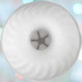 A top view of a white bundt cake with a smooth, swirled design, reminiscent of the elegant lines seen in the Svakom Robin Vibrating Masturbation Sleeve by Svakom, set against a softly blurred, colorful background. The cake's central hole reveals a hint of the textured interior.