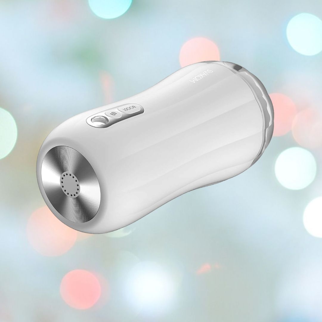 The Svakom Robin Vibrating Masturbation Sleeve - White by Svakom features a sleek, modern design with metallic accents. One end is adorned with a button and a decorative circular pattern. Its BOOST feature elevates performance, and softly blurred colorful lights add a festive ambiance.