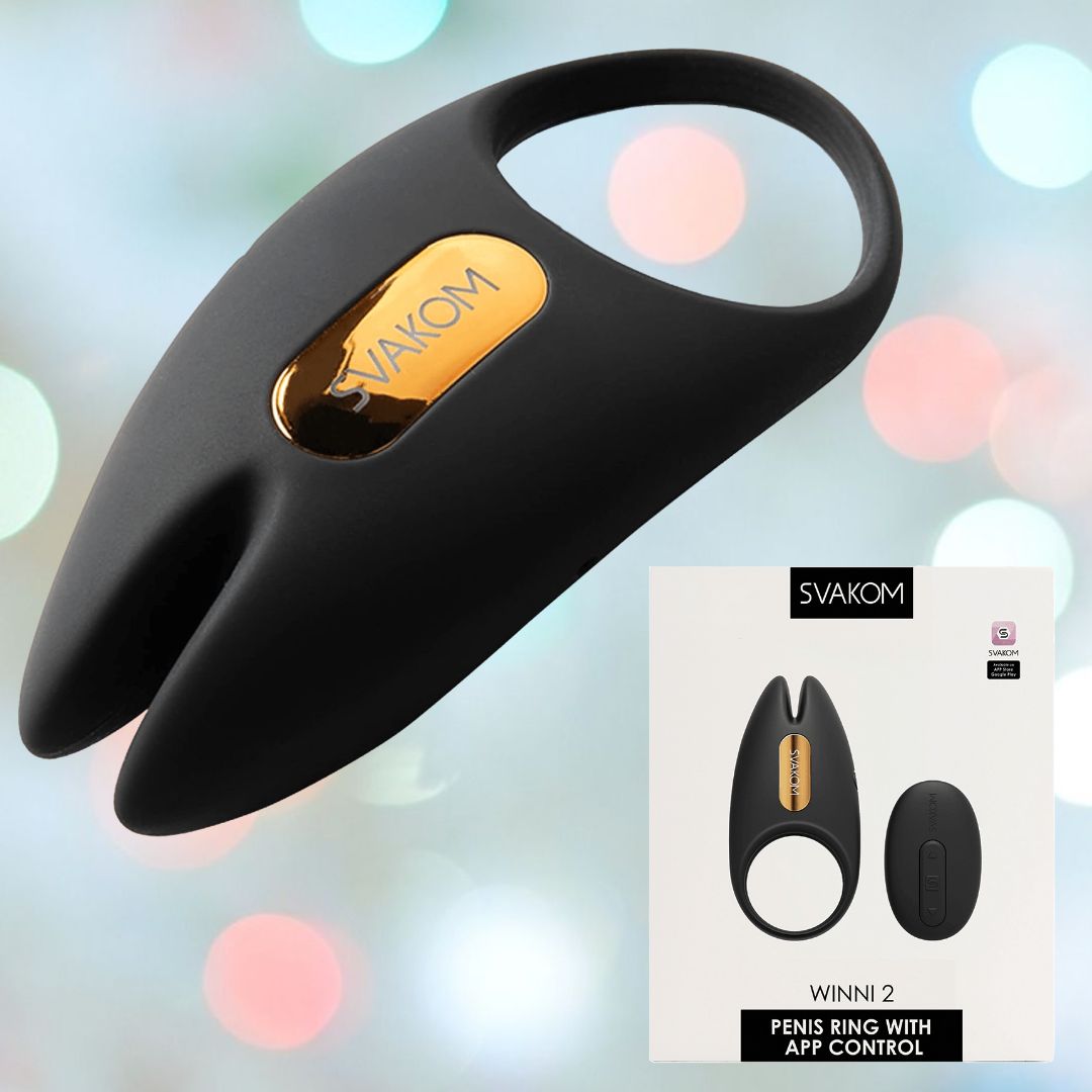 The "Svakom Winni 2 Penis Ring w/ App Control (Black)" by Svakom is a black, silicone vibrating ring with a gold accent. The packaging showcases the product prominently, emphasizing its function as an app-controlled couples' toy set against a softly blurred pastel backdrop.