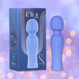 The Swan Era Wand by BMS, a blue personal massager with a powerful PowerBullet motor, stands next to its matching box displaying "The Swan ERA Wand" in gold lettering amid a purple background and glowing bokeh lights.