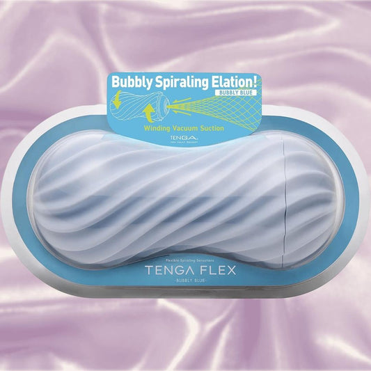 The Tenga Flex Bubbly Blue reusable pleasure sleeve is shown in its box against light purple satin, featuring a wavy, textured design. The packaging boasts “Bubbly Spiraling Elation!” and powerful suction sensations. 1080
