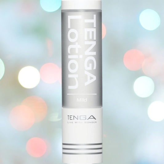 The tall cylindrical TENGA Hole Lotion "Mild" Lubricant bottle, in silver and white, offers a silky glide. A bokeh of colorful lights serves as the background. At the bottom, "TENGA Live With Wonder" highlights its water-based lubricant quality.
. 1080