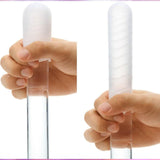 Two hands hold the TENGA Pocket Click Ball, a disposable textured male masturbator by Tenga. Its pocket-sized, super-stretchy elastomer design is displayed from two angles against a plain background.