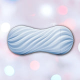 The TENGA Flex Stroker Toy by Tenga, a light blue cylindrical sleeve with a spiral design and wavy texture, is centered against a soft pastel background with blurred circular lights in pink, white, and blue hues.